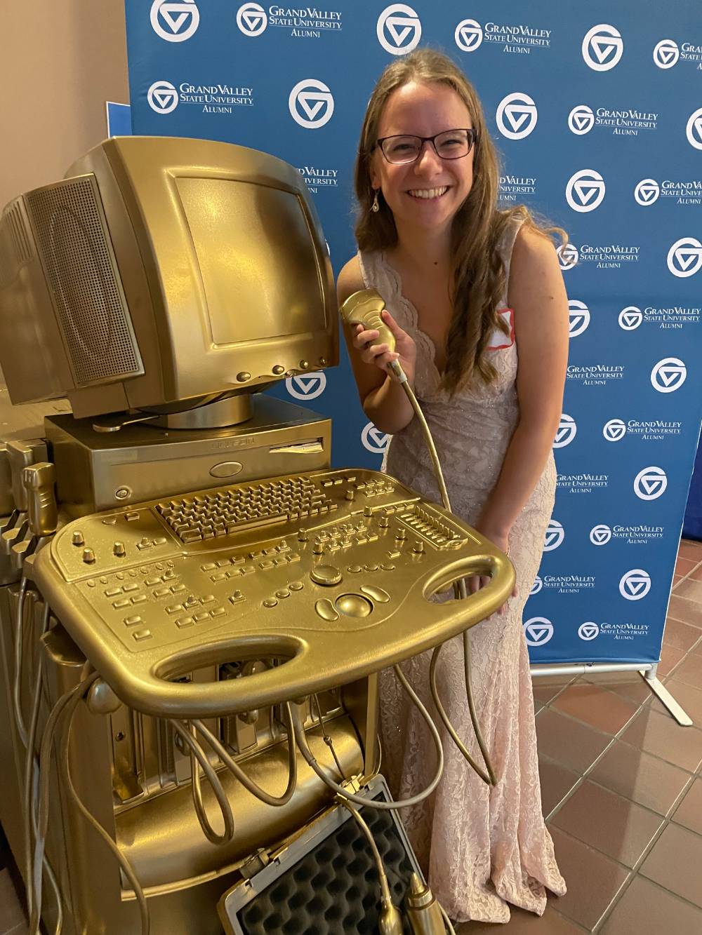 Alum standing with the medical sonography computer table.